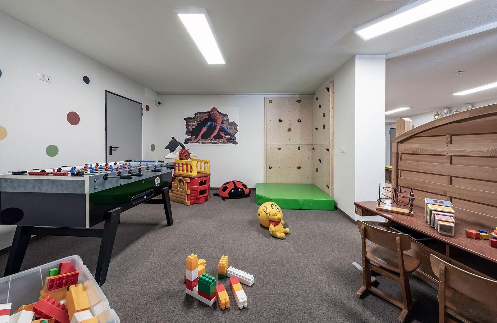 Children's playroom at Pension Wiesenrain with foosball, climbing wall, and games.